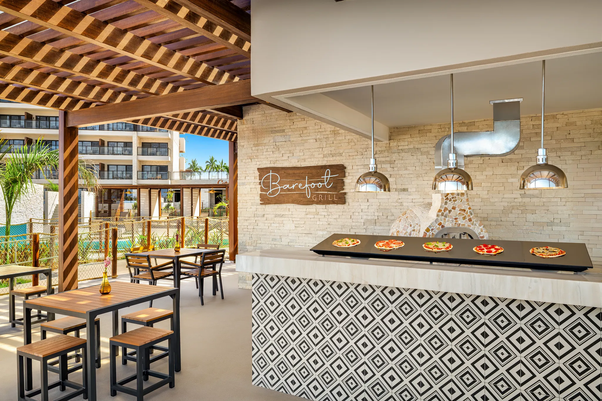 Barefoot Grill poolside restaurant at Dreams Estrella del Mar Mazatlan serving fresh pizza and grilled favorites in a casual open-air setting.