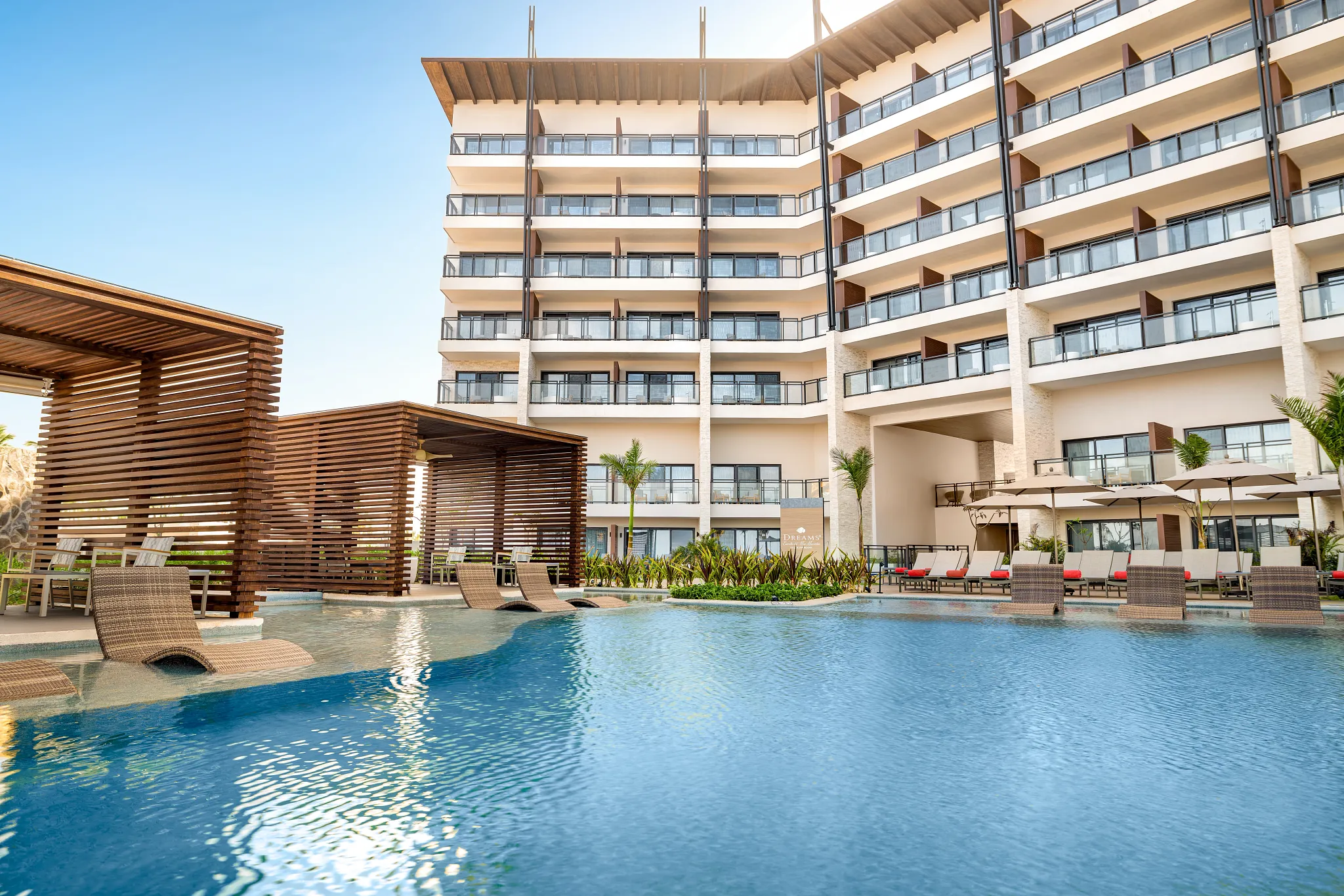 Adults-only pool with in-water loungers and private cabanas at Dreams Estrella del Mar Mazatlan Golf & Spa Resort in Mazatlán.