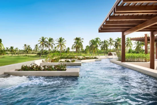 Outdoor hydrotherapy circuit with flowing pools and palm trees at Dreams Estrella del Mar Mazatlan Golf & Spa Resort spa.