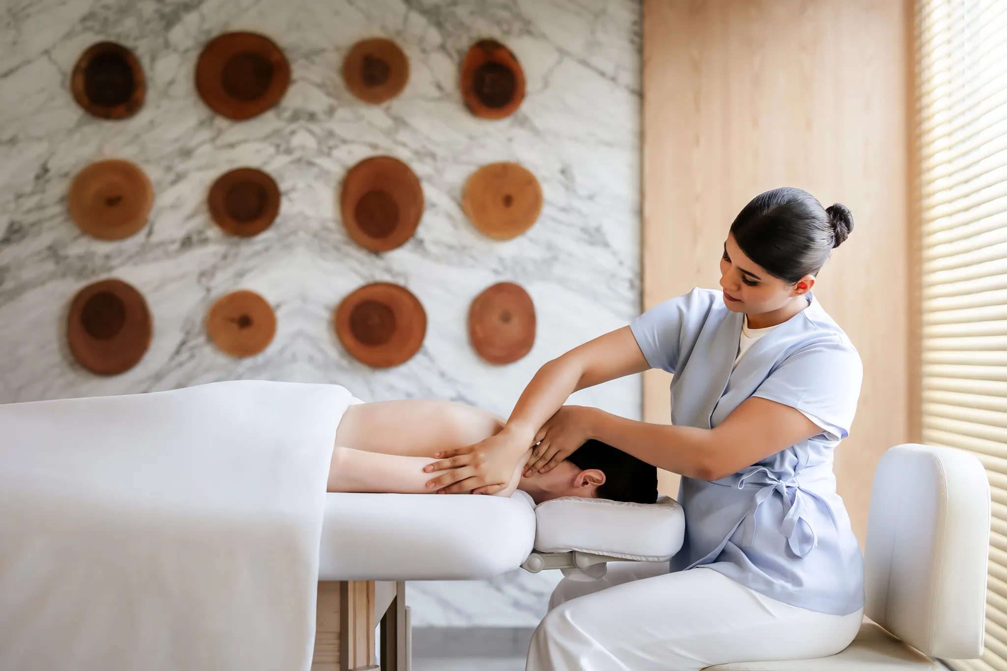 Spa therapist giving a relaxing massage treatment at Dreams Estrella del Mar Mazatlan Golf & Spa Resort.