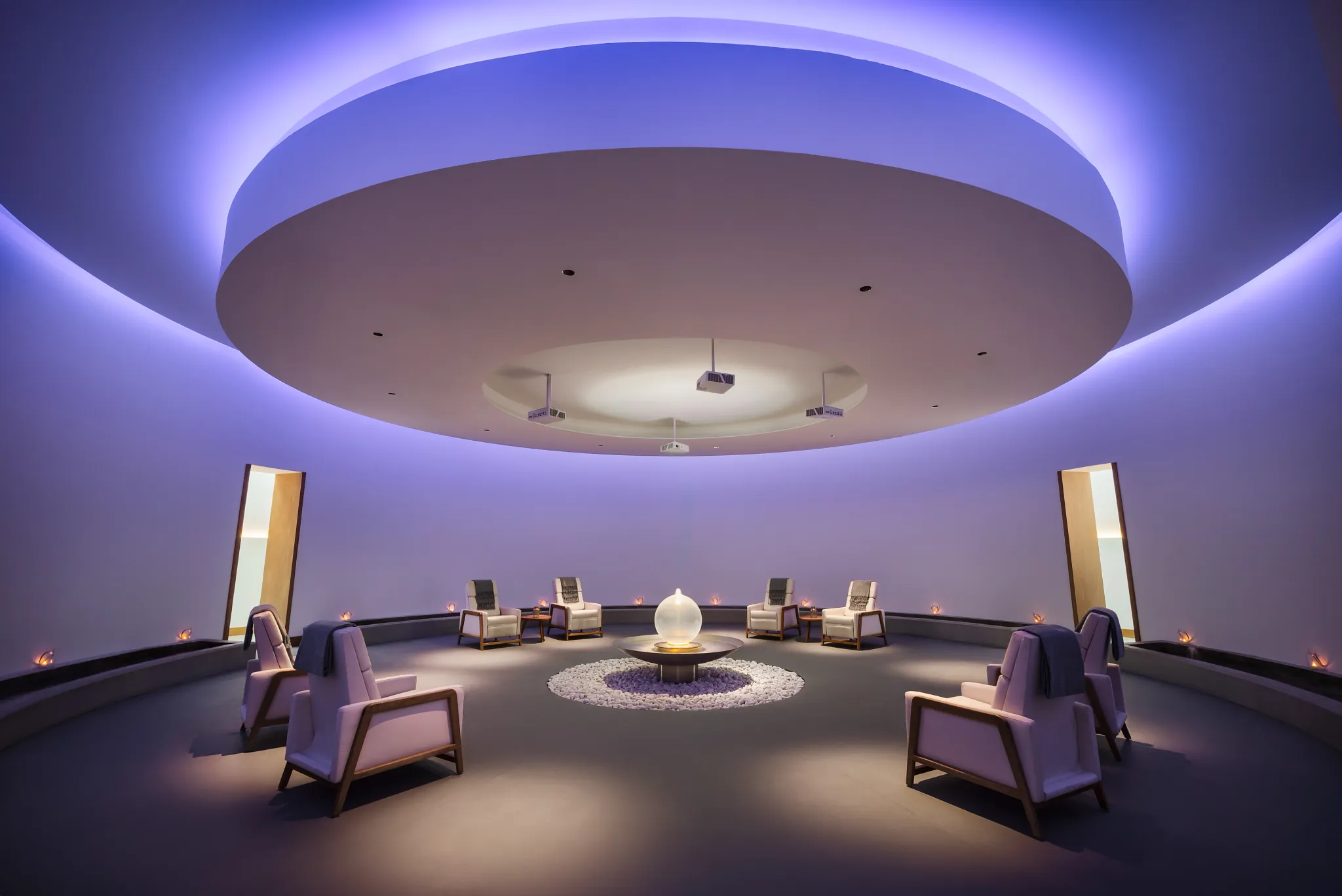 Circular spa relaxation room with ambient lighting and lounge chairs at Dreams Estrella del Mar Mazatlan Golf & Spa Resort.