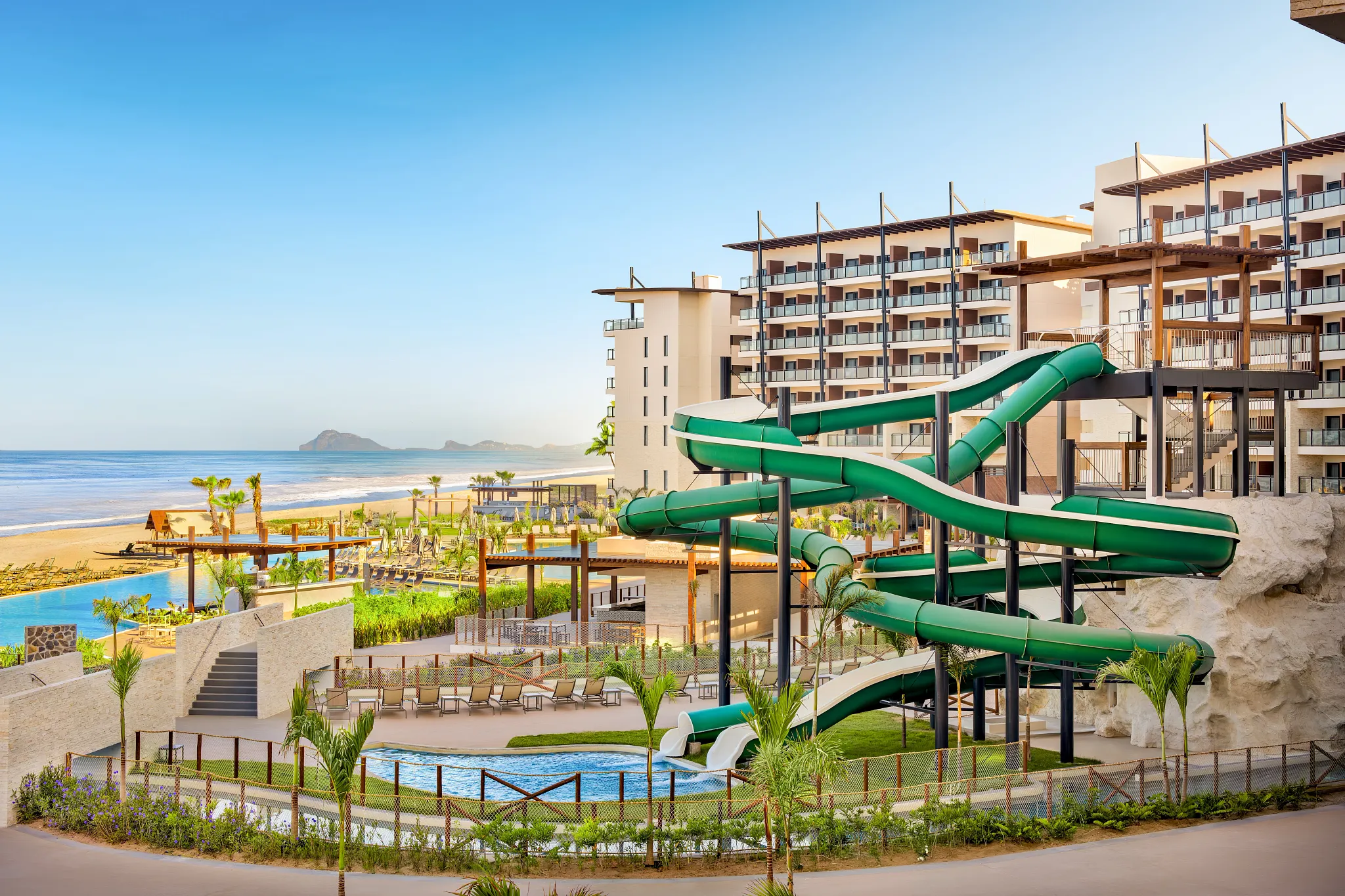 Resort waterpark with slides and pools overlooking the beach at Dreams Estrella del Mar Mazatlan Golf & Spa Resort.