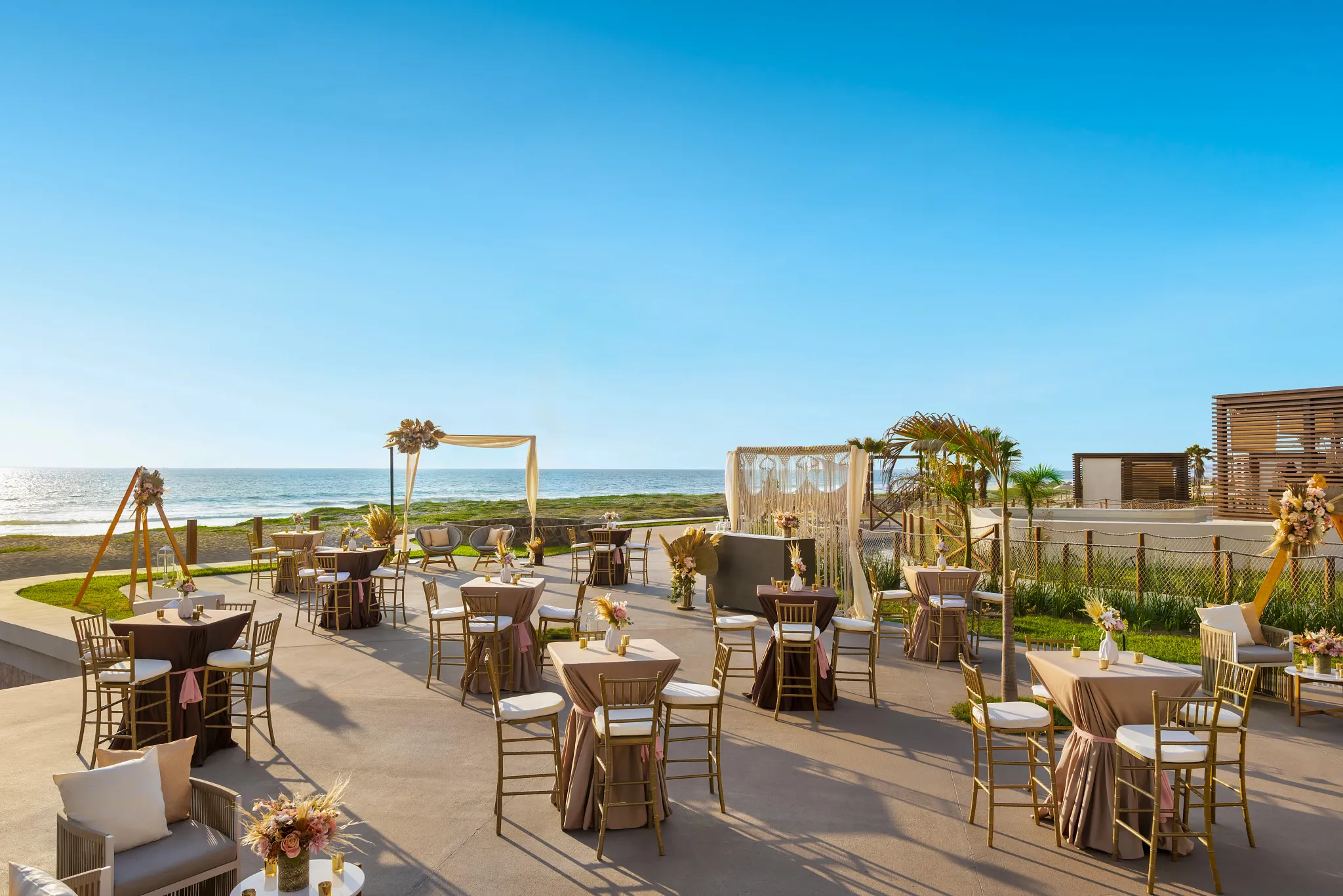 Oceanfront cocktail reception setup with high tables and sunset views at Dreams Estrella del Mar Mazatlán Golf & Spa Resort