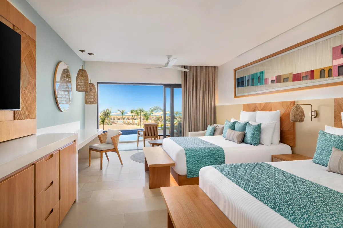 Junior Suite Swim Out with two double beds and poolfront terrace at Dreams Estrella del Mar Mazatlan Golf & Spa Resort.