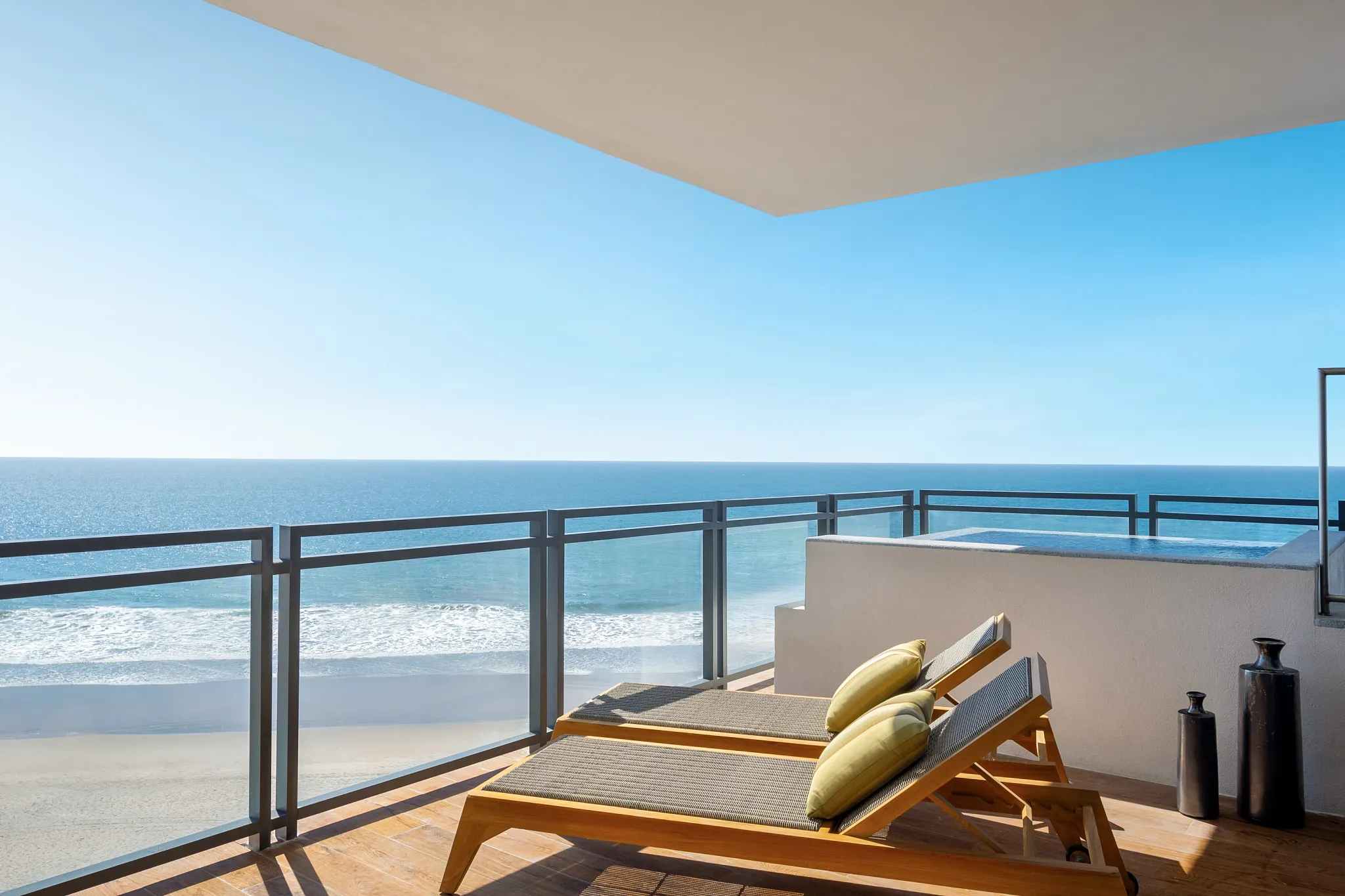 One-Bedroom Presidential Suite Ocean Front balcony with loungers and outdoor hot tub at Dreams Estrella del Mar Mazatlan.
