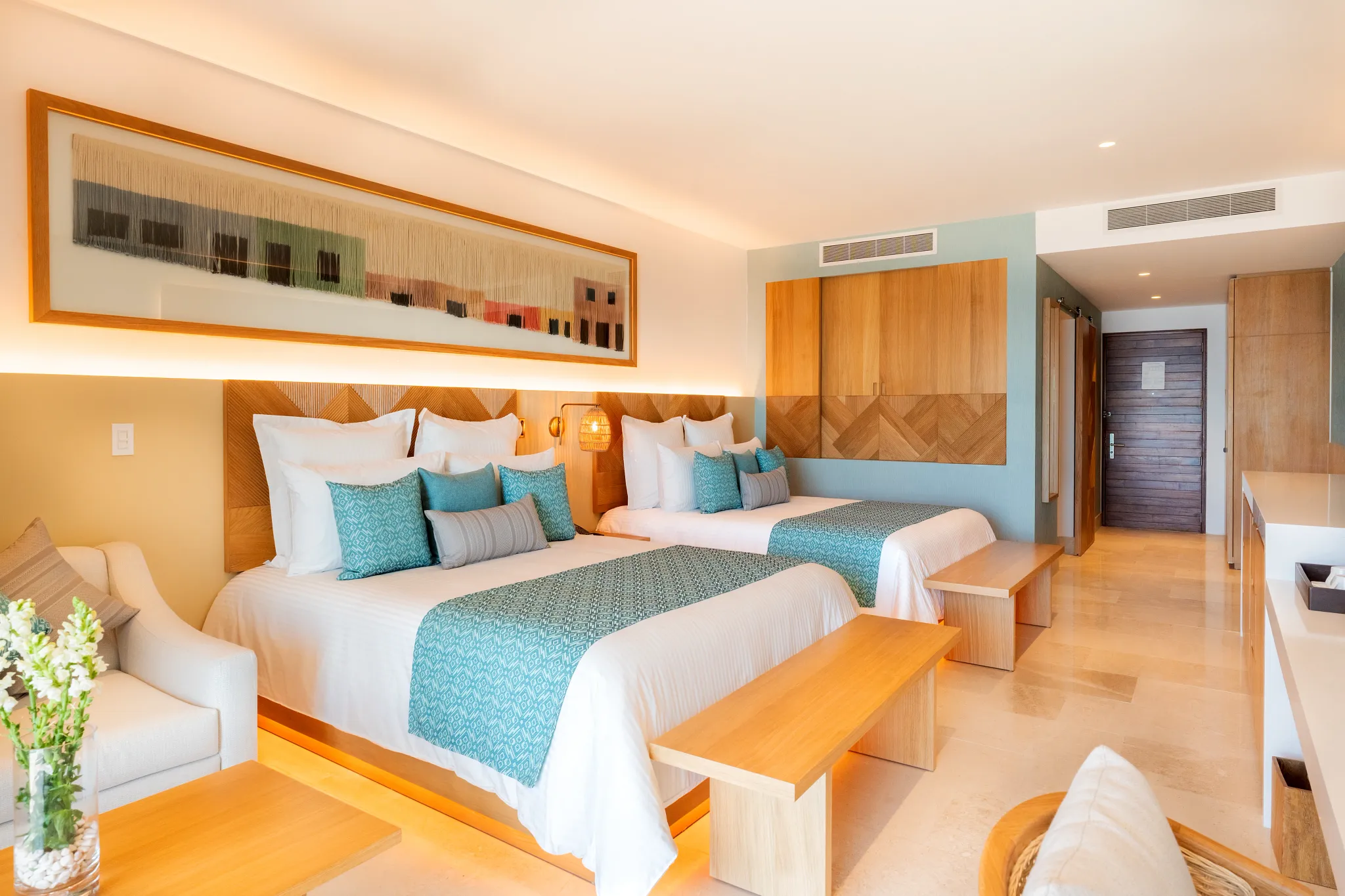 Preferred Club Junior Suite Ocean Front with two double beds and modern coastal design at Dreams Estrella del Mar Mazatlan.