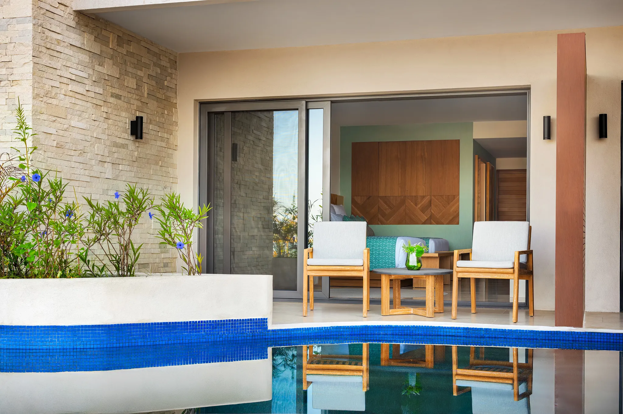 Preferred Club Junior Suite Swim Out terrace with chairs and direct pool access at Dreams Estrella del Mar Mazatlan.