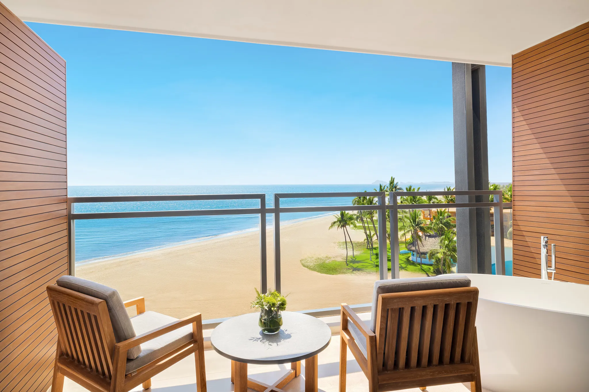 Preferred Club Premium Ocean Front balcony with seating and panoramic ocean views at Dreams Estrella del Mar Mazatlan.