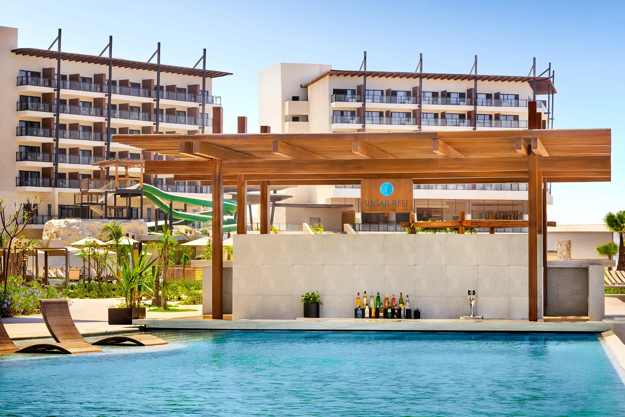 Sugar Reef swim-up bar at Dreams Estrella del Mar Mazatlan featuring a poolside bar serving tropical cocktails in a resort pool setting.